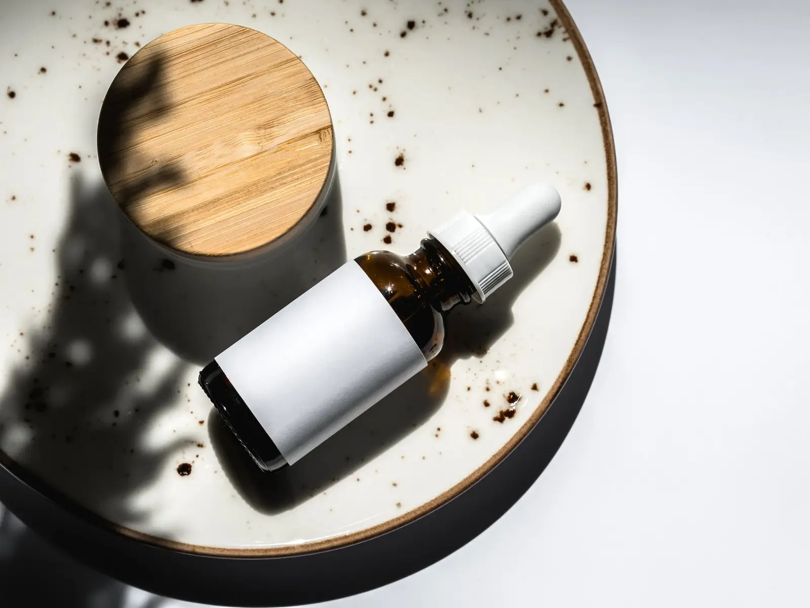 Skincare bottle on a ceramic plate
